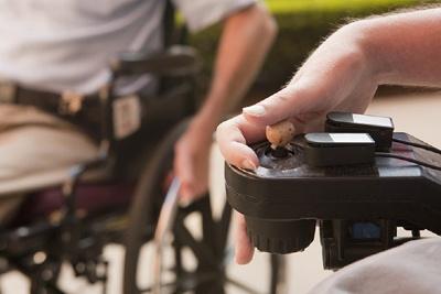 Hand working the mechanism on an electric wheelchair