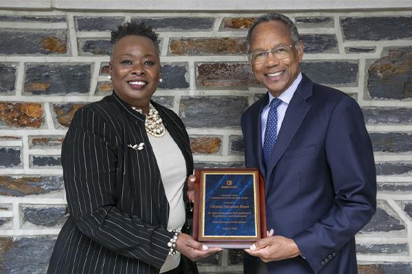 Gloria Bass receiving the Susan B Clark award from Chancellor Washington