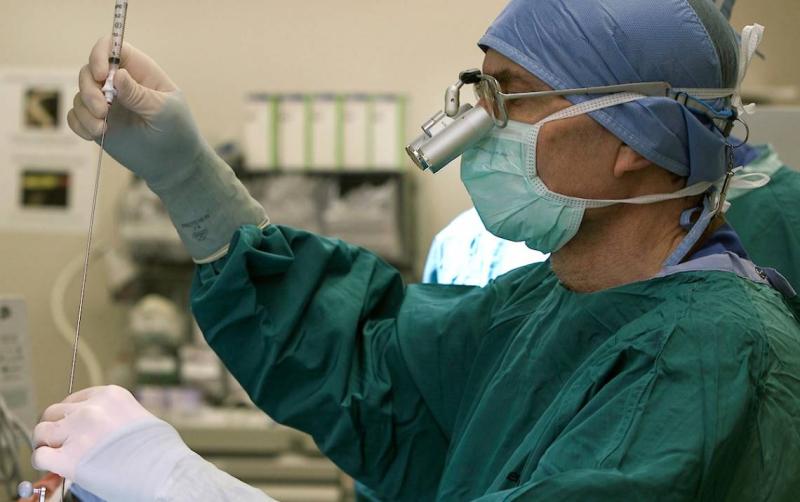 Surgeon performing a glioblastoma biopsy