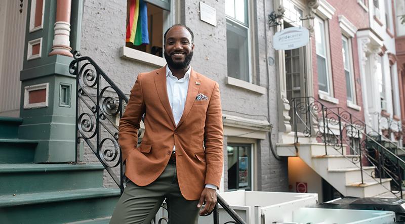 Man stands on steps outside NY apartment building