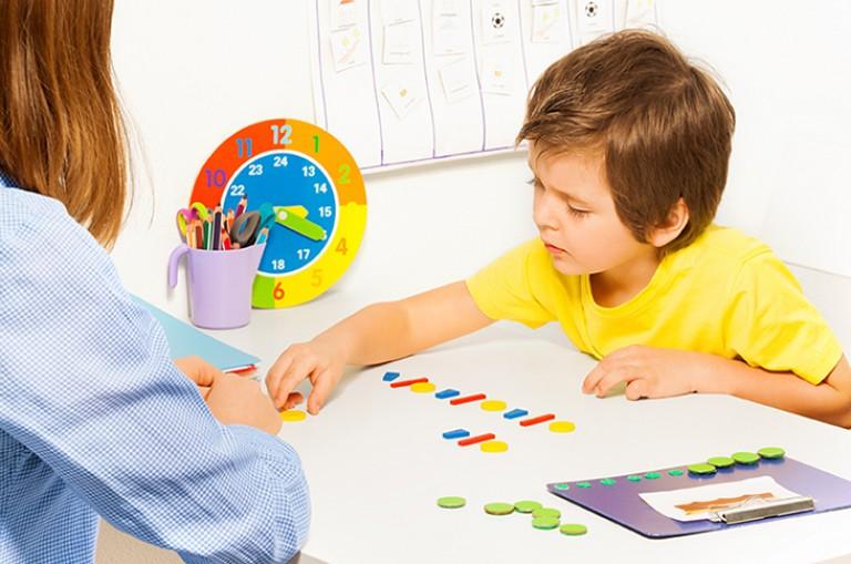 Young boy playing with brightly colored tiles