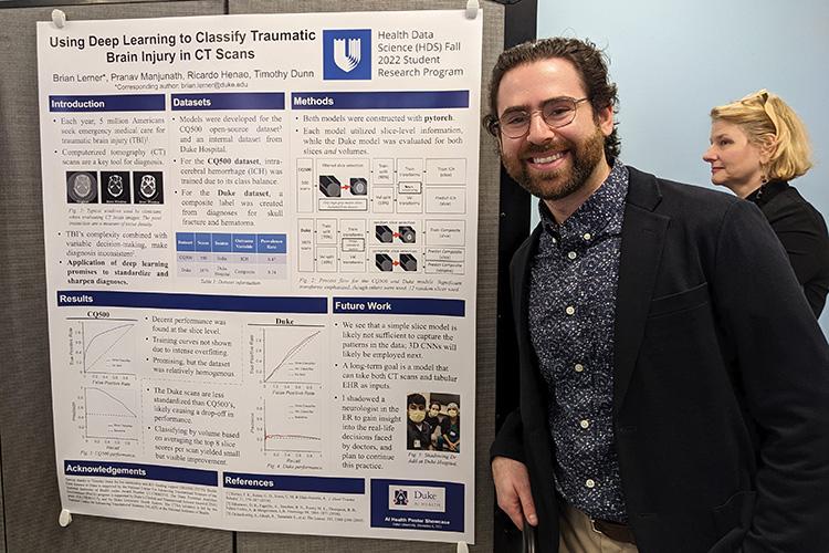 Brian Lerner in front of his poster