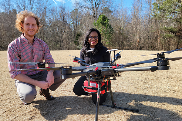 Two researchers with a Drone with an AED attached