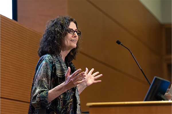 Titia de Lange, PhD at a podium