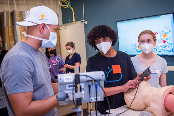 High School students in the HPREP program learning how to intubate a mannequin 