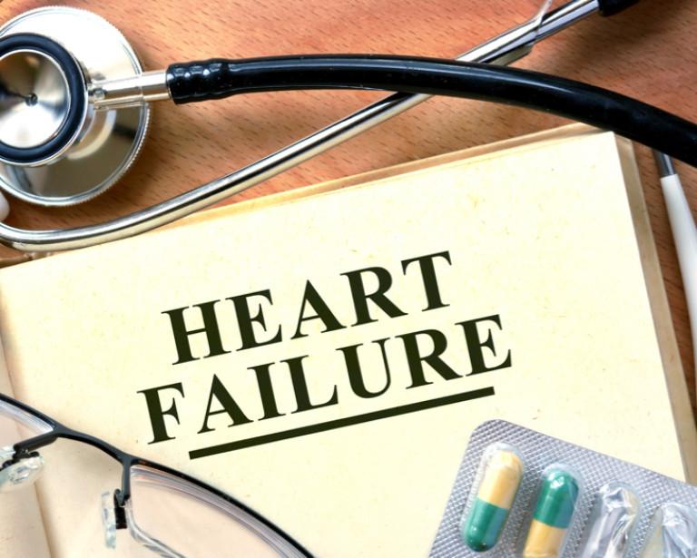 Heart Failure written on a file, surrounded by a stethoscope and medication in a blister pack. 