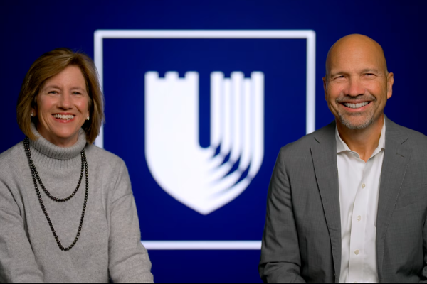 Video Still of Mary E. Klotman and Craig Albanese in front of the Duke Health Logo