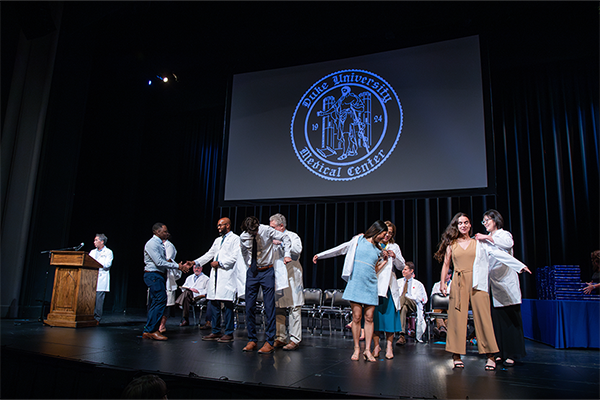 Students receiving their white coats at the SoM MD program white coat ceremony. 