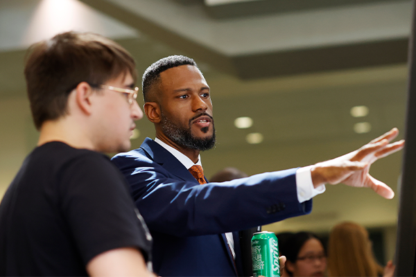 Marcus Lambert, PhD, Associate Vice President for Research Strategy and Operations, Associate Professor Dept. of Epidemiology & Biostatistics at SUNY Downstate Health Sciences University, talks with Duke MGM student Marco Gontijo about Gontijo’s research