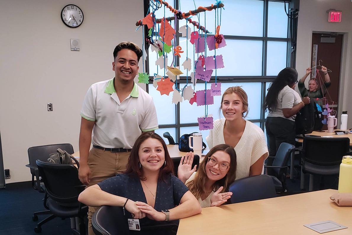 four students with their mobile