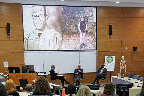 Jeffrey Baker, Damon Tweedy, and producer Beverley Abel speak about the podcast in a lecture hall