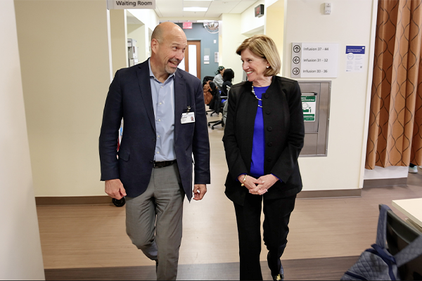 Craig Albanese and Mary Klotman walking through Duke Clinics together