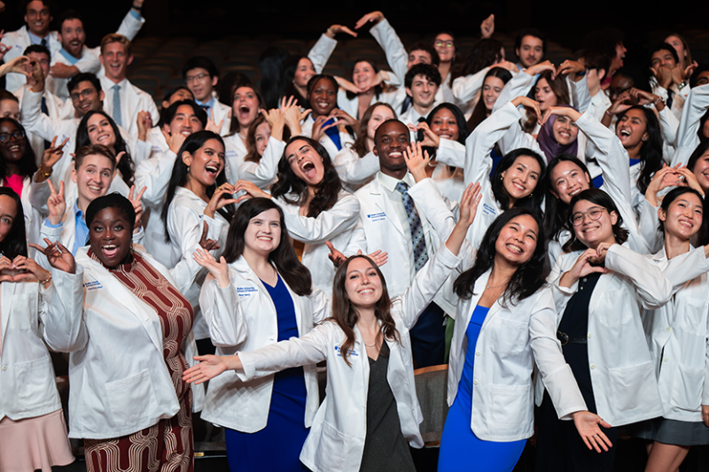 First year MD students strike funny poses after receiving their white coats. 