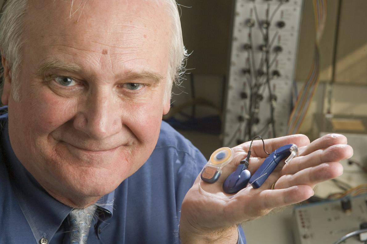 Blake Wilson holding cochlear implant