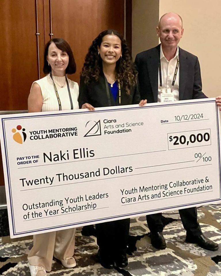 Naki Ellis receiving a Super-sized check for $20,000