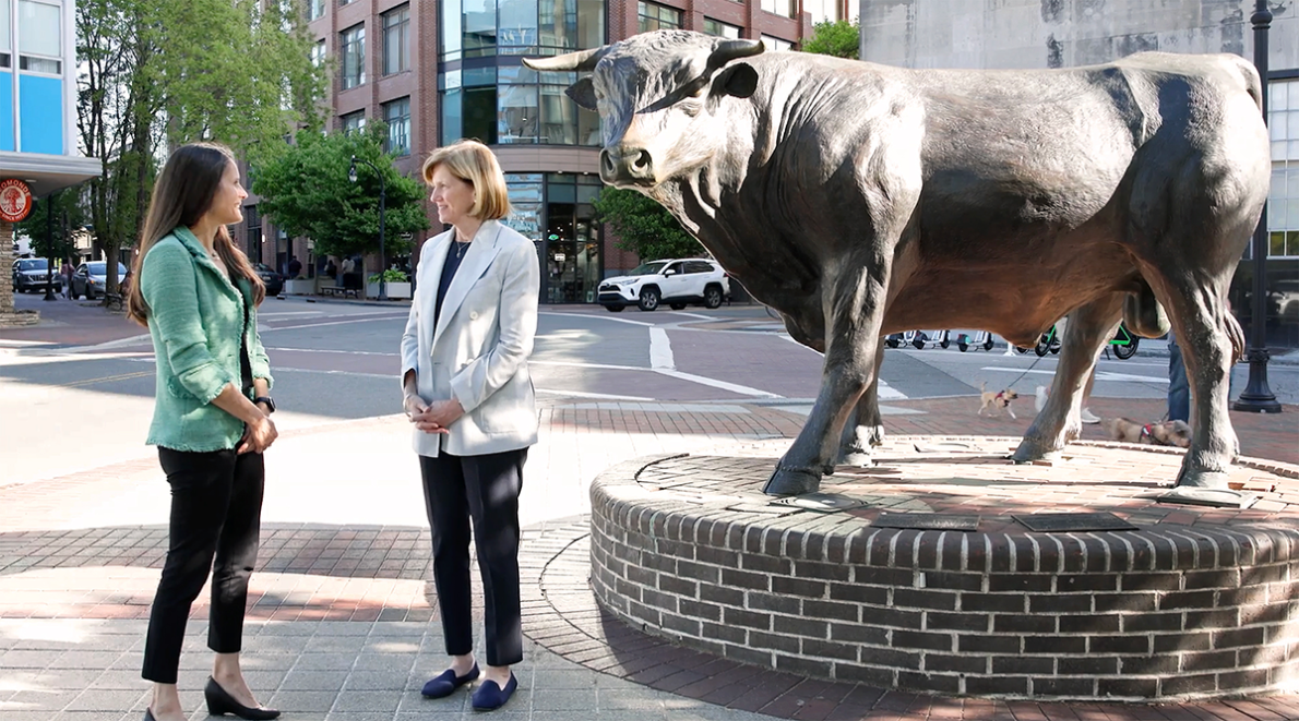Dean Mary Klotman & Dr. Susanna Naggie, downtown standing next to the Durham Bull sculpture.