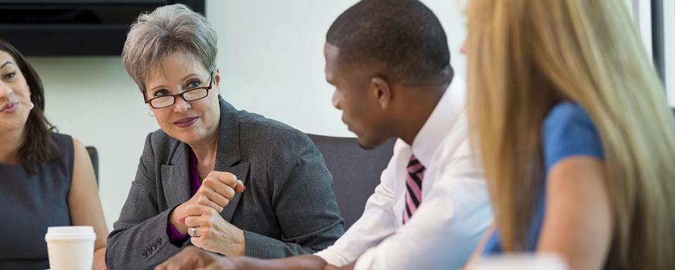 four professionals speak at a meeting