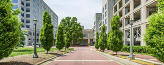 External view of North pavilion, tree lined drive to front of building