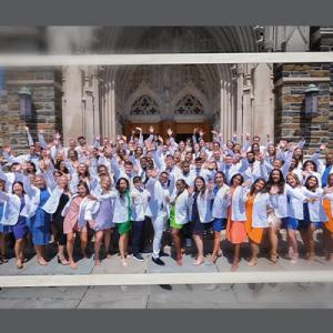 Doctor of Physical Therapy Class of 2022 in their white coats in front of the Duke Chapel.
