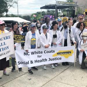 Poor People's March - Duke Faculty holding "NC White Coats for Social and Health Justice" banner
