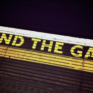 Text on subway floor that says "mind the gap"