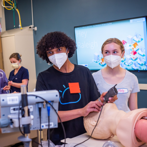 High School students in the HPREP program learning how to intubate a mannequin 