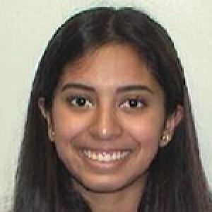 Headshot of Neha Majety with hear brown hair in front of her shoulders