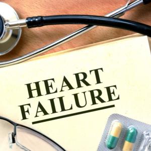 Heart Failure written on a file, surrounded by a stethoscope and medication in a blister pack. 