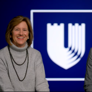Video Still of Mary E. Klotman and Craig Albanese in front of the Duke Health Logo