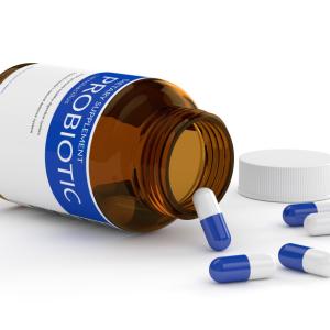 Pills spilling out of a bottle labeled "probiotic'