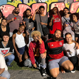 Hip-Hop Pedagogies team pose in front of mural in Brazil 