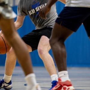 view of the legs of various basketball players with the ball in play. 