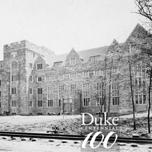 Original Duke Hospital while under construction, Duke Centennial logo in foreground
