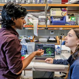 Professor talking to student at a lab bench