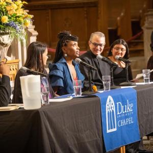 Panelists sit at table at Duke Chapel 