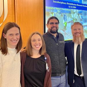 the 3 co-leaders of the Rehab Group with a speaker