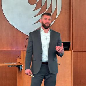 Dr. Grooms talking at the front of the IPE lecture hall