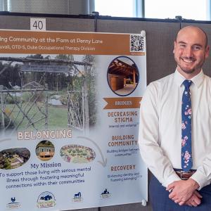 ray next to his poster he's presenting at a spring 2024 event on Duke's campus