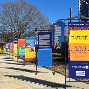 colorful panels lined up on a sidewalk outside the Museum of Durham History