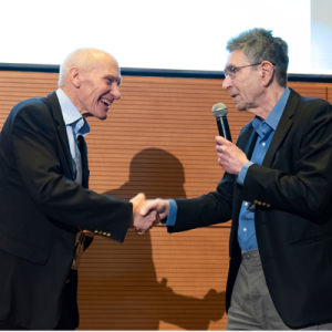 Carl June, MD being greeted by Robert Lefkowitz, MD at the 2025 Robert Lefkowitz Distinguished Lecture