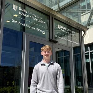 Matthew posing in front of Duke's IPE building
