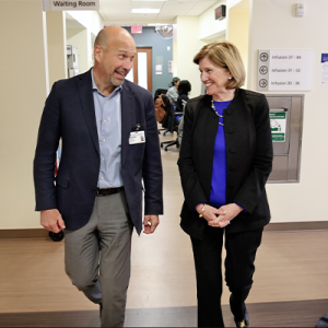 Craig Albanese and Mary Klotman walking through Duke Clinics together