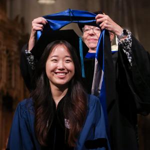 Jisun having her graduation shawl put on by the division chief