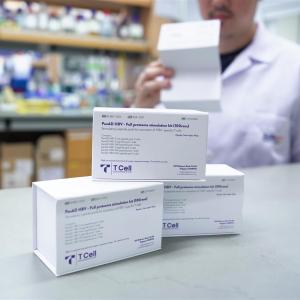 Image: A man in a lab coat stands with three boxes, suggesting involvement in a laboratory or research activity.