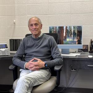 Portrait of Dr. Michael Hershfield sitting in his office
