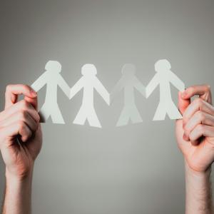 Hand holding paper cutout