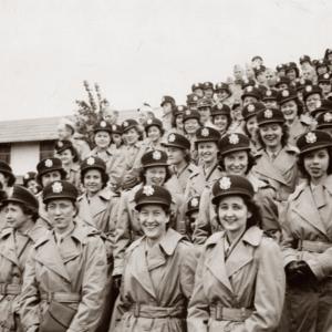 Uniformed nurses and servicemen of the 65th General Hospital awaiting embarkation for overseas duties. 