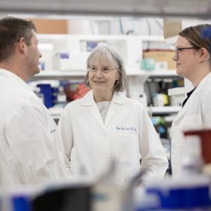 Virginia Byers Kraus, MD, PhD, speaking with colleagues in the lab.