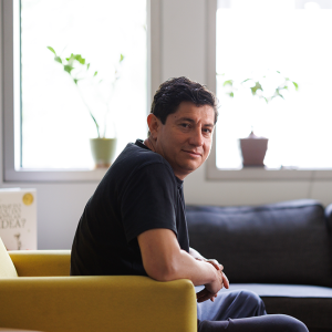 Diego Bohorquez, PhD sitting in an armchair in his lab