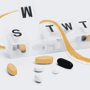 A pill container and several types of pills and capsules